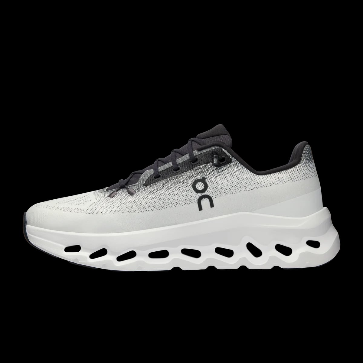 On Cloudtilt — black / ivory — medial view (official reference photograph)